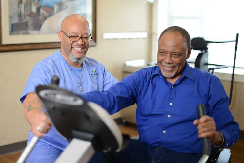 man on exercise bike under attendant supervision