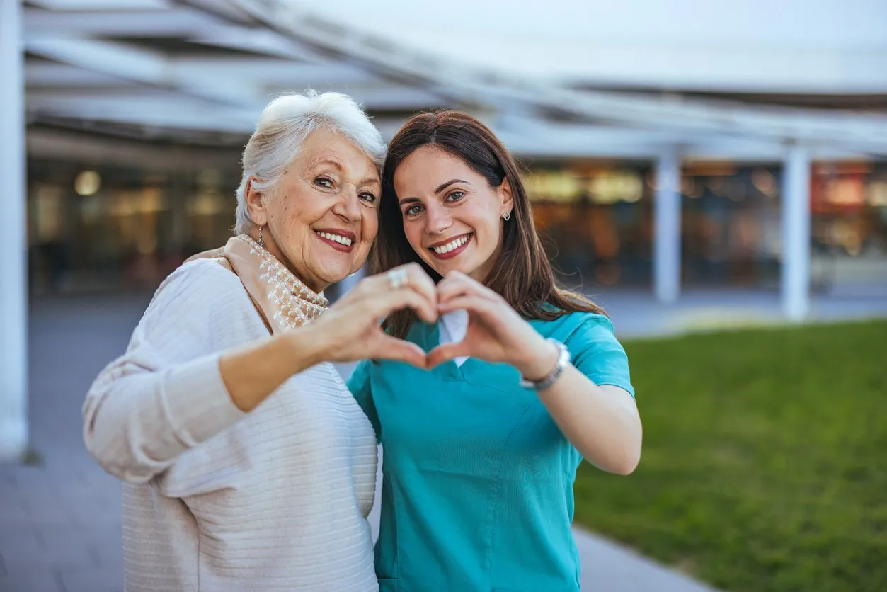 Friends doing the joined heart hands